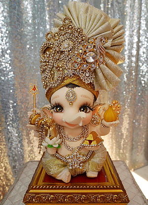 Adorned Baby Lord Ganesha Figurine with Gold Crown and Jewels HD phone wallpaper