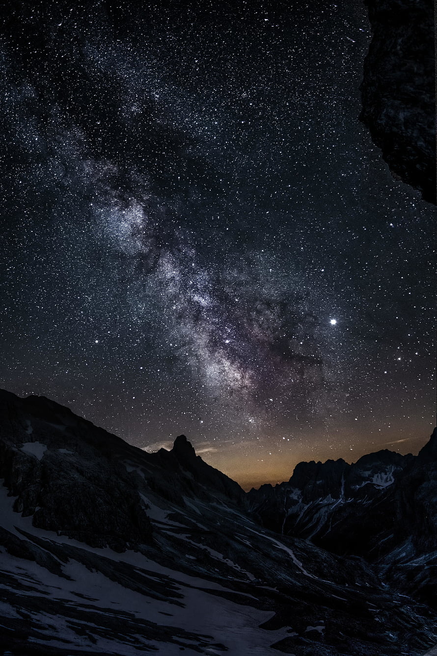 Milky Way Galaxy Arching Over Snow-Capped Mountain Ridges at Night HD phone wallpaper