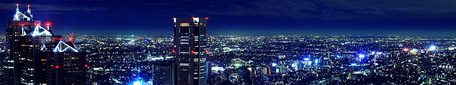 Panoramic Night Cityscape with Glowing Skyscrapers and Deep Blue Sky HD wallpaper