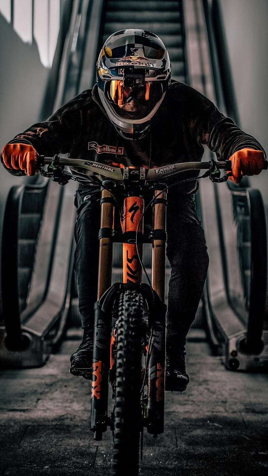Fabio Wibmer Riding Orange Mountain Bike in Urban Setting HD phone wallpaper