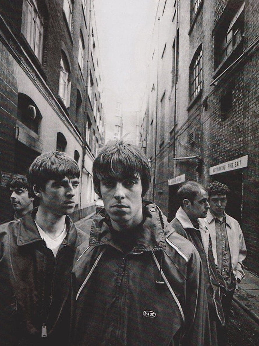 Oasis Band Members Walking Through a Narrow Urban Alley in Black and White HD phone wallpaper