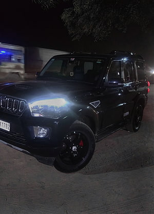 Black Mahindra Scorpio SUV with Custom Black Rims and Bright Headlights at Night HD phone wallpaper