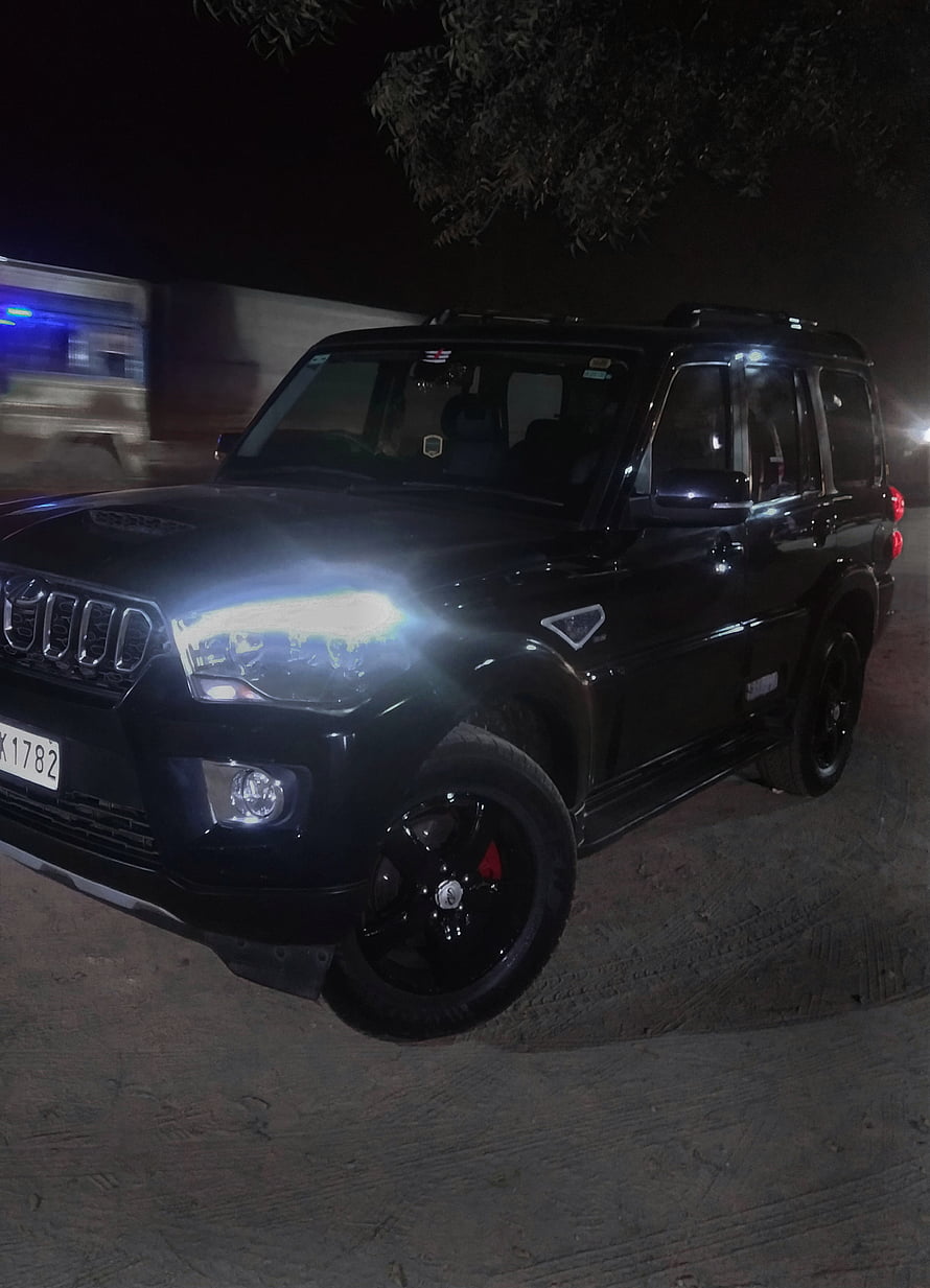 Black Mahindra Scorpio SUV with Custom Black Rims and Bright Headlights at Night HD phone wallpaper