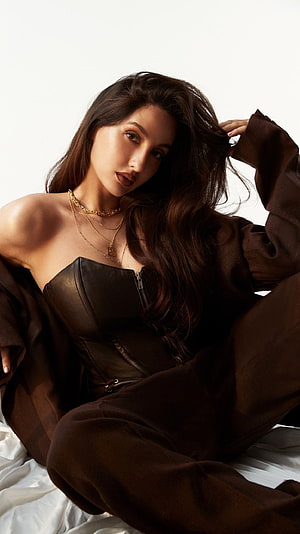 Nora Fatehi in a brown leather corset and oversized blazer with layered gold necklaces HD phone wallpaper