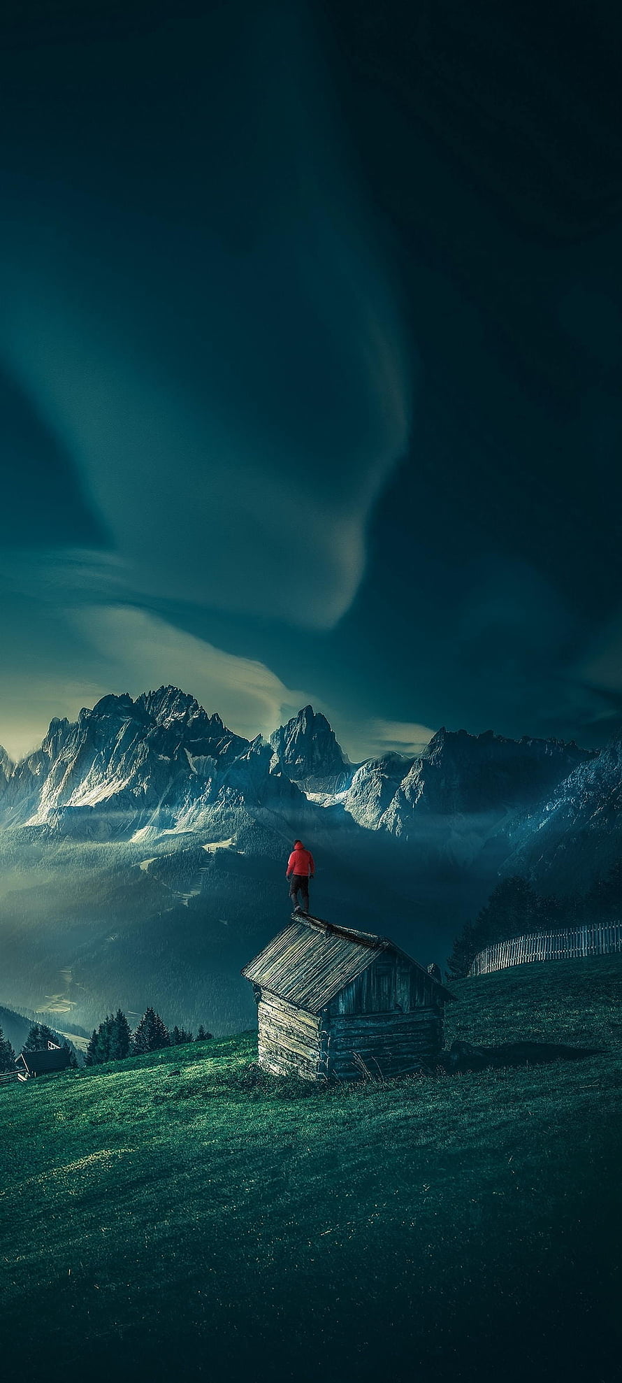 Lone Hiker on Alpine Cabin Roof with Dramatic Mountain Peaks and Misty Valley HD phone wallpaper