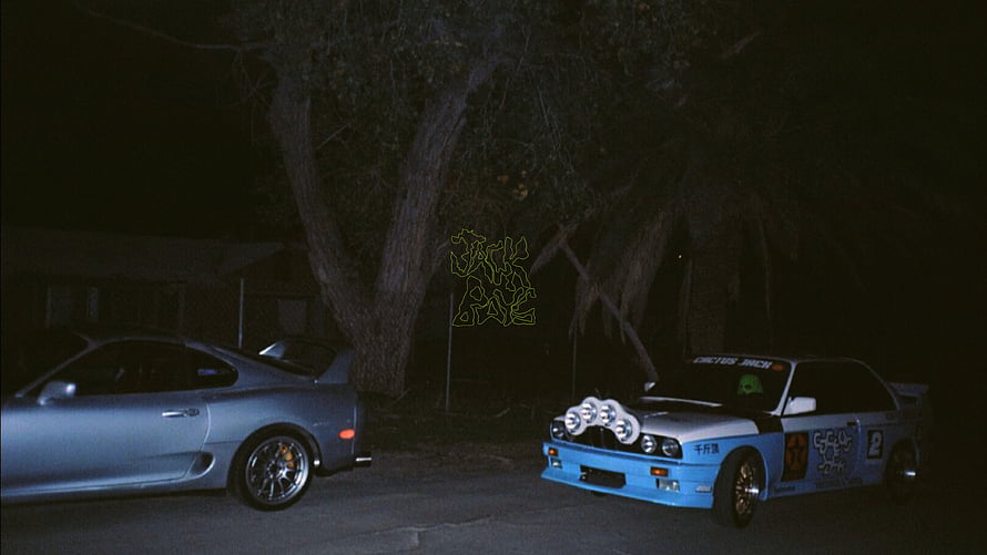Nighttime Street Scene Featuring a Silver Coupe and a Blue Racing Car with Auxiliary Lights HD wallpaper