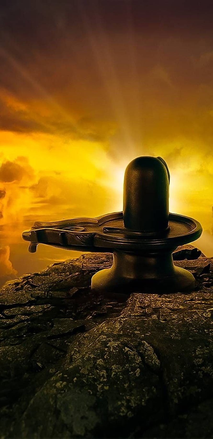 Shiva Linga on Rocky Outcrop Against Golden Sunset Sky HD phone wallpaper