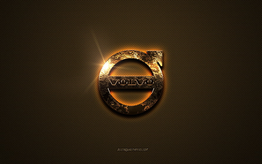 Volvo Emblem with Golden Glow on Dark Textured Metal Surface HD wallpaper