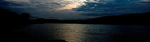 Serene Twilight Lake with Silhouetted Hills and Cloudy Sky HD wallpaper