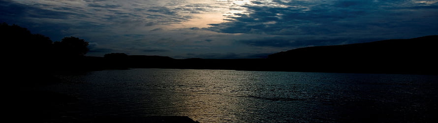 Serene Twilight Lake with Silhouetted Hills and Cloudy Sky HD wallpaper