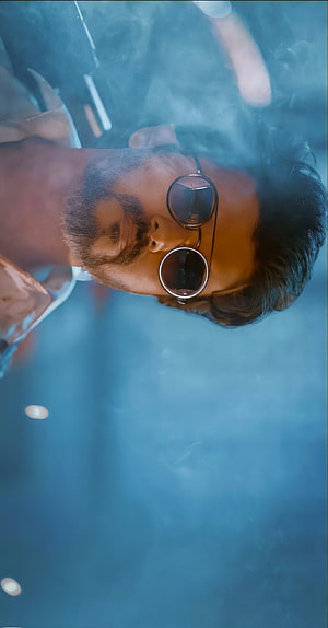 Thalapathy Vijay in Round Sunglasses with Dramatic Blue Smoke and Cinematic Lighting HD phone wallpaper