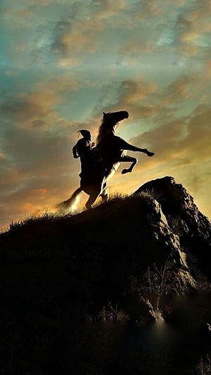 Silhouette of Chhatrapati Shivaji on a rearing horse atop a rocky hill at sunset HD phone wallpaper