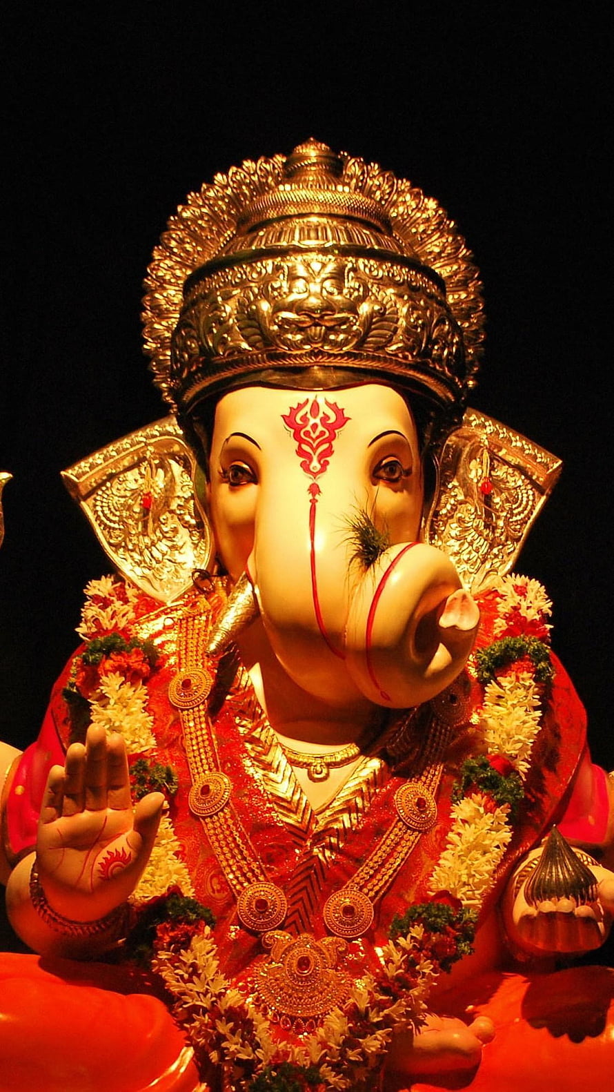 Ornate Ganesha Murti Adorned in Red Garments and Golden Crown HD phone wallpaper