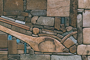 Rustic Wood Mosaic Texture with Carved Spoon and Scattered Timber Pieces HD wallpaper