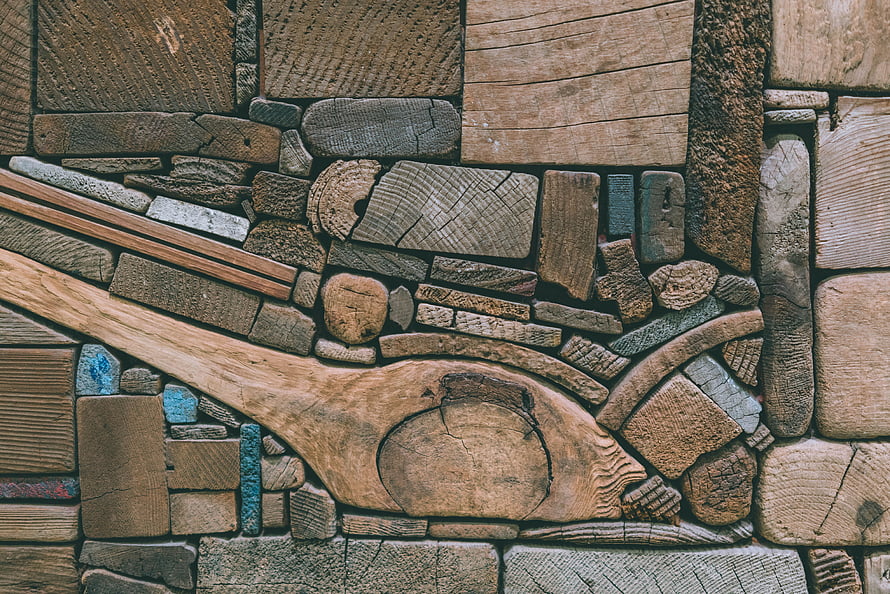 Rustic Wood Mosaic Texture with Carved Spoon and Scattered Timber Pieces HD wallpaper