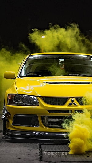 Yellow Mitsubishi Lancer Evolution Front View with Smoke Effect at Night HD phone wallpaper