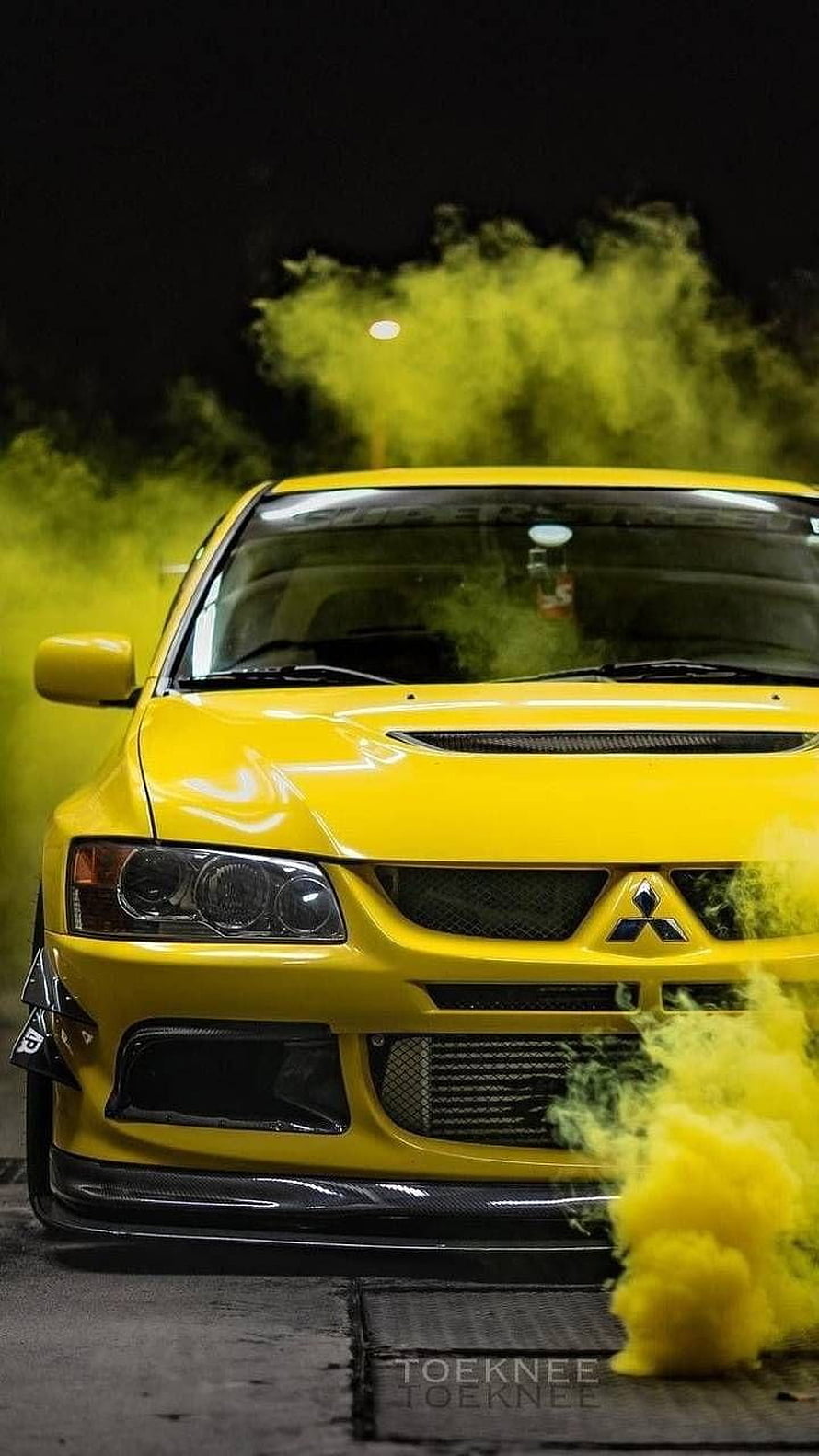 Yellow Mitsubishi Lancer Evolution Front View with Smoke Effect at Night HD phone wallpaper