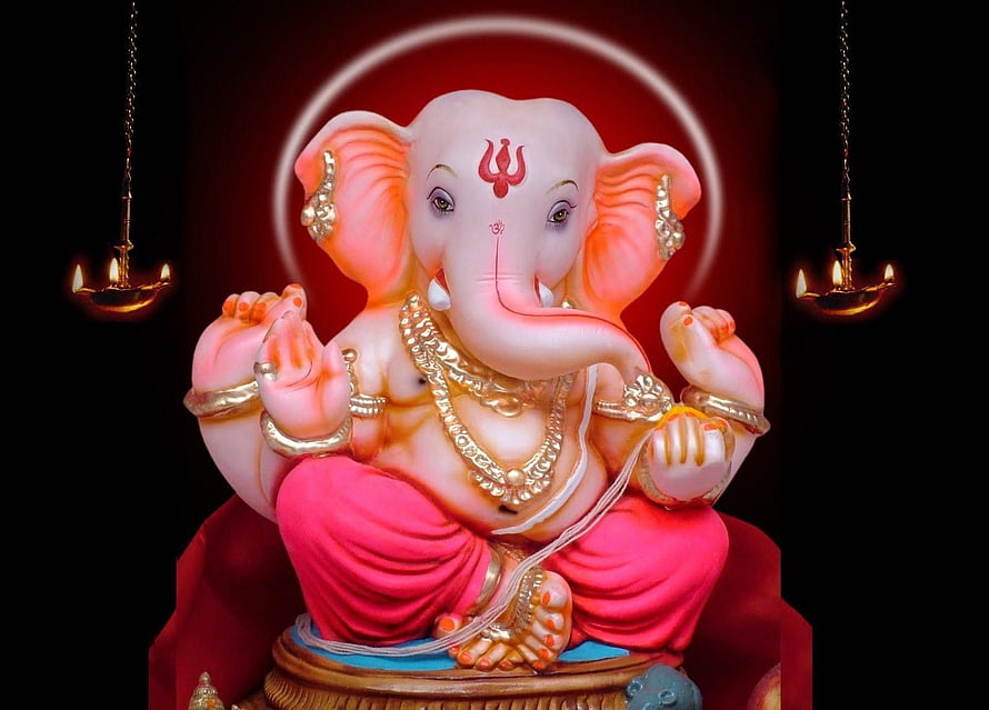 Lord Ganesha Seated Statue with Golden Jewelry and Diya Lamps on Red Background HD wallpaper
