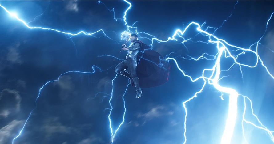Thor wielding Mjolnir amid a storm of blue lightning in the Marvel Cinematic Universe HD wallpaper