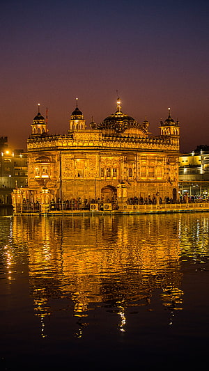 Golden Temple at Dusk: Illuminated Sikh Shrine and Water Reflection in Amritsar, Punjab HD phone wallpaper