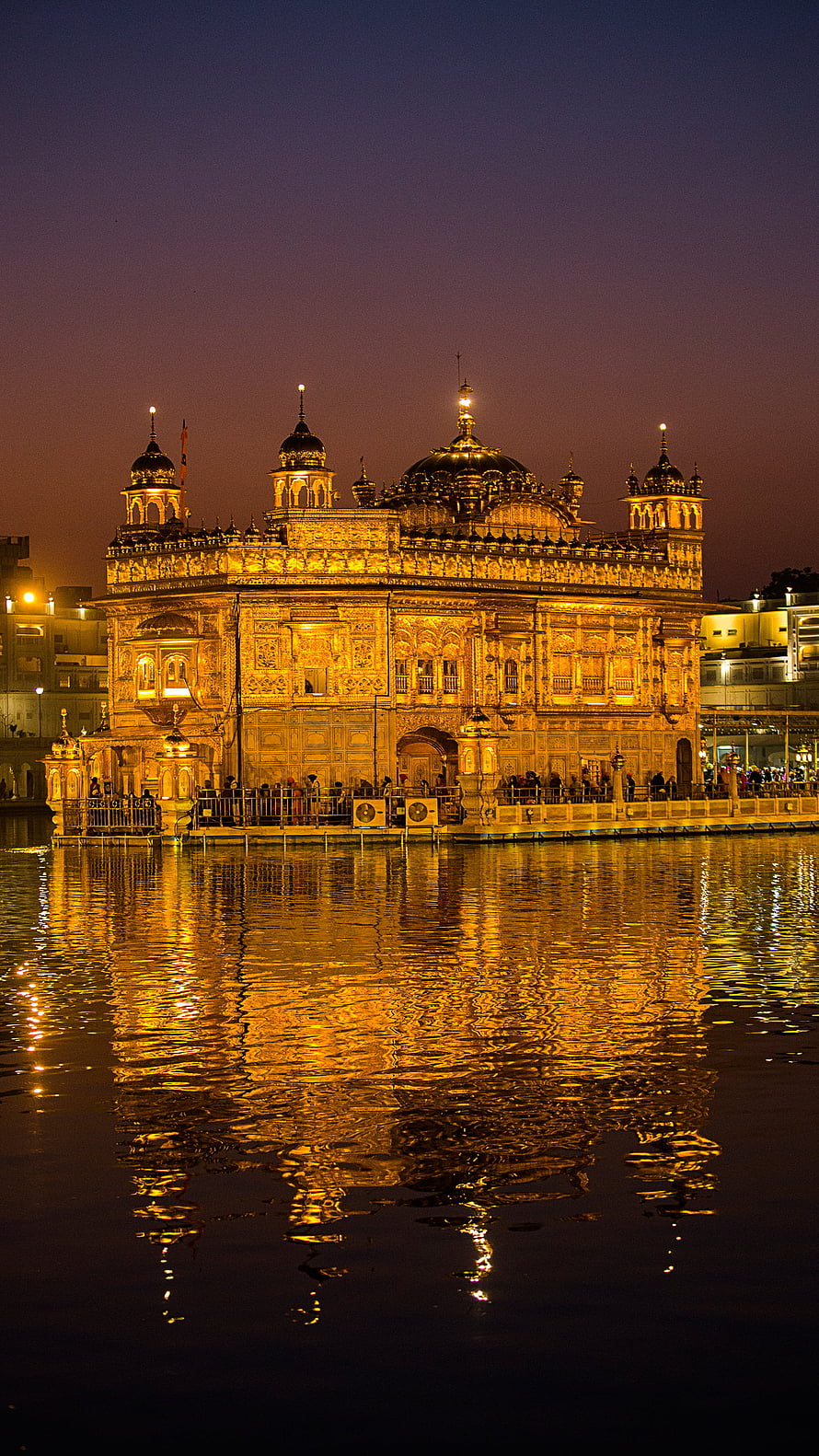 Golden Temple at Dusk: Illuminated Sikh Shrine and Water Reflection in Amritsar, Punjab HD phone wallpaper