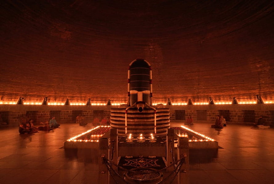 Dhyanalinga Sacred Shrine Illuminated by Rows of Oil Lamps in a Circular Meditation Hall HD wallpaper