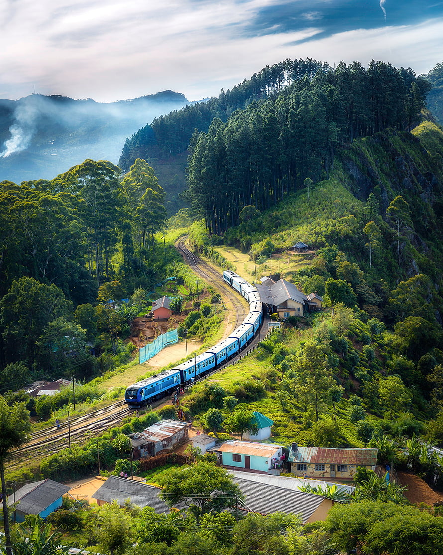 Blue Train Winding Through Lush Green Hills of an Indian Hill Station HD phone wallpaper