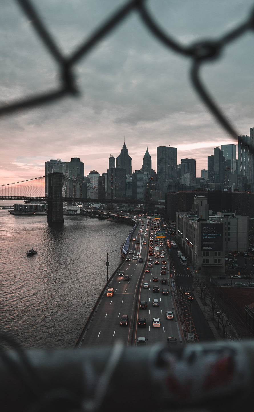 New York City Skyline at Dusk Viewed Through Chain Link Fence HD phone wallpaper