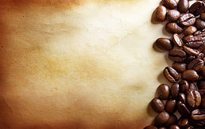 Roasted Coffee Beans on Textured Parchment Paper with Warm Vintage Background HD wallpaper