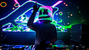 Marshmello DJ performing live with LED mask and neon stage lighting HD wallpaper