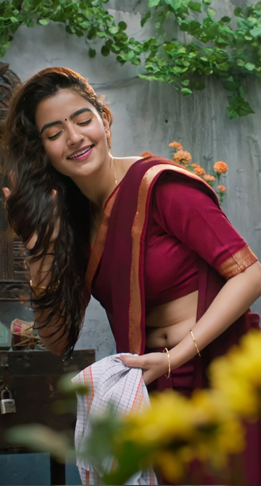 Rukshar Dhillon in a maroon saree with gold border, smiling with eyes closed in a garden setting HD phone wallpaper