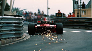 Classic Ferrari Formula 1 Car Drifting Through Sparks on a Street Circuit HD wallpaper