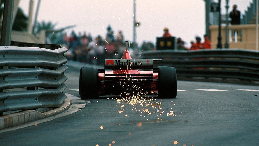 Classic Ferrari Formula 1 Car Drifting Through Sparks on a Street Circuit HD wallpaper