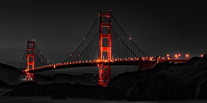 Golden Gate Bridge Illuminated in Red Against a Dark Night Sky in San Francisco HD wallpaper