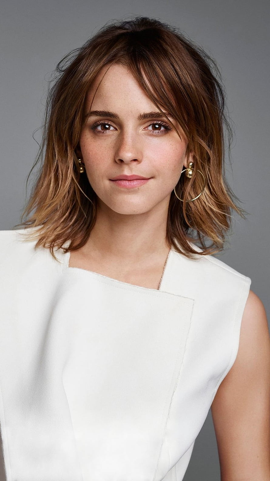 Emma Watson Studio Portrait in White Sleeveless Top with Gold Hoop Earrings HD phone wallpaper