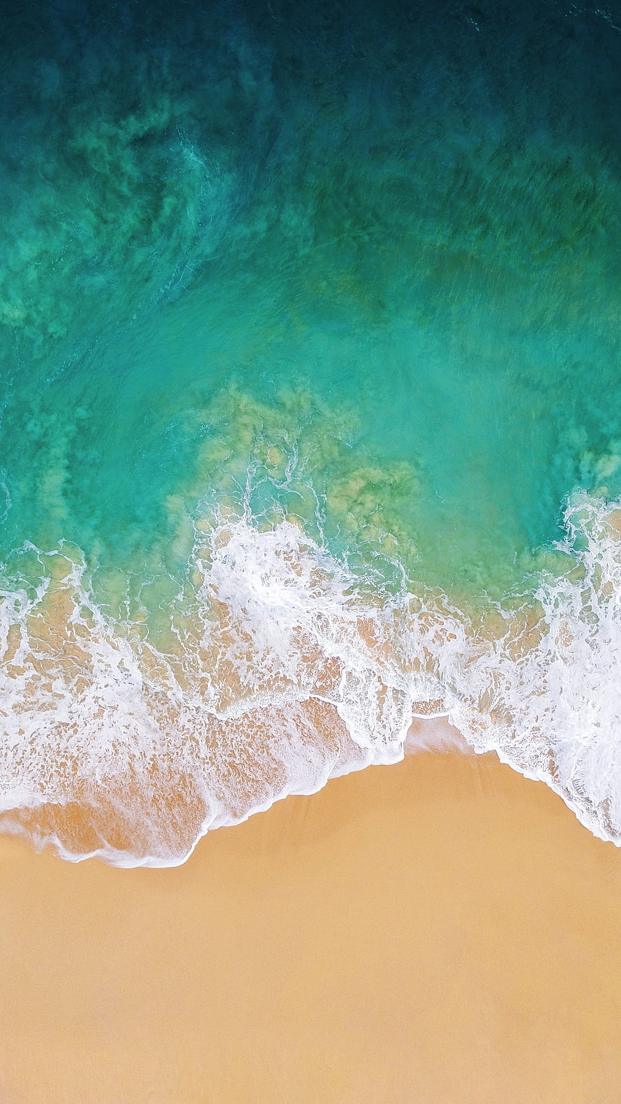 Aerial View of Turquoise Ocean Waves Rolling onto a Golden Sandy Beach HD phone wallpaper
