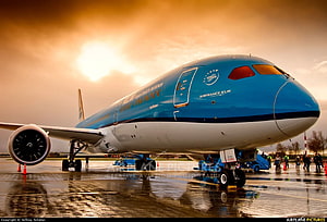 KLM Boeing 787-9 Dreamliner on the tarmac at sunset with warm golden light HD wallpaper