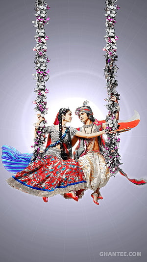 Radha Krishna on a Flower-Adorned Swing in Traditional Indian Attire HD phone wallpaper