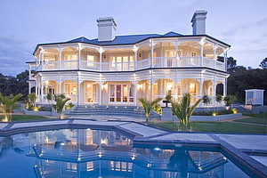 Elegant Two-Story White Mansion With Wraparound Porch And Reflecting Pool At Dusk HD wallpaper