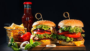 Gourmet Cheeseburgers with Fresh Vegetables and French Fries on Dark Background HD wallpaper