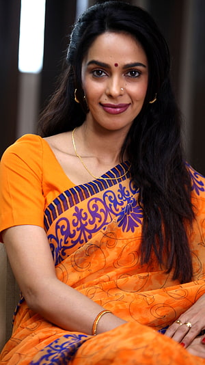 Mallika Sherawat in Vibrant Orange Saree with Traditional Gold Jewelry HD phone wallpaper