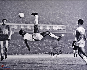 Pele performing an iconic bicycle kick in a vintage black and white football match HD wallpaper