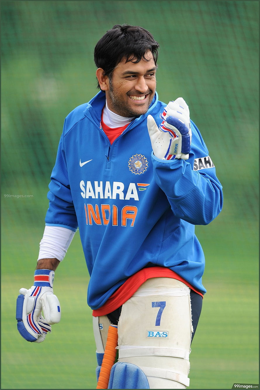 MS Dhoni in Indian cricket training gear smiling on the field HD phone wallpaper