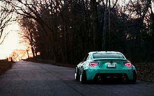Rear View of a Mint Green Toyota GT86 Parked on a Tree-Lined Road at Sunset HD wallpaper