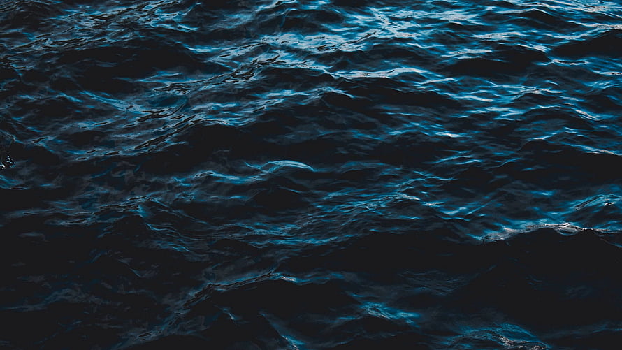 Dark Ocean Water Surface with Deep Blue Ripples and Gentle Waves HD wallpaper