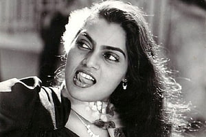 Silk Smitha Black and White Portrait with Intense Expression and Flowing Hair HD wallpaper