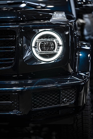 Mercedes-Benz G-Class Front Headlight Close-Up with LED Ring and Grille Detail HD phone wallpaper