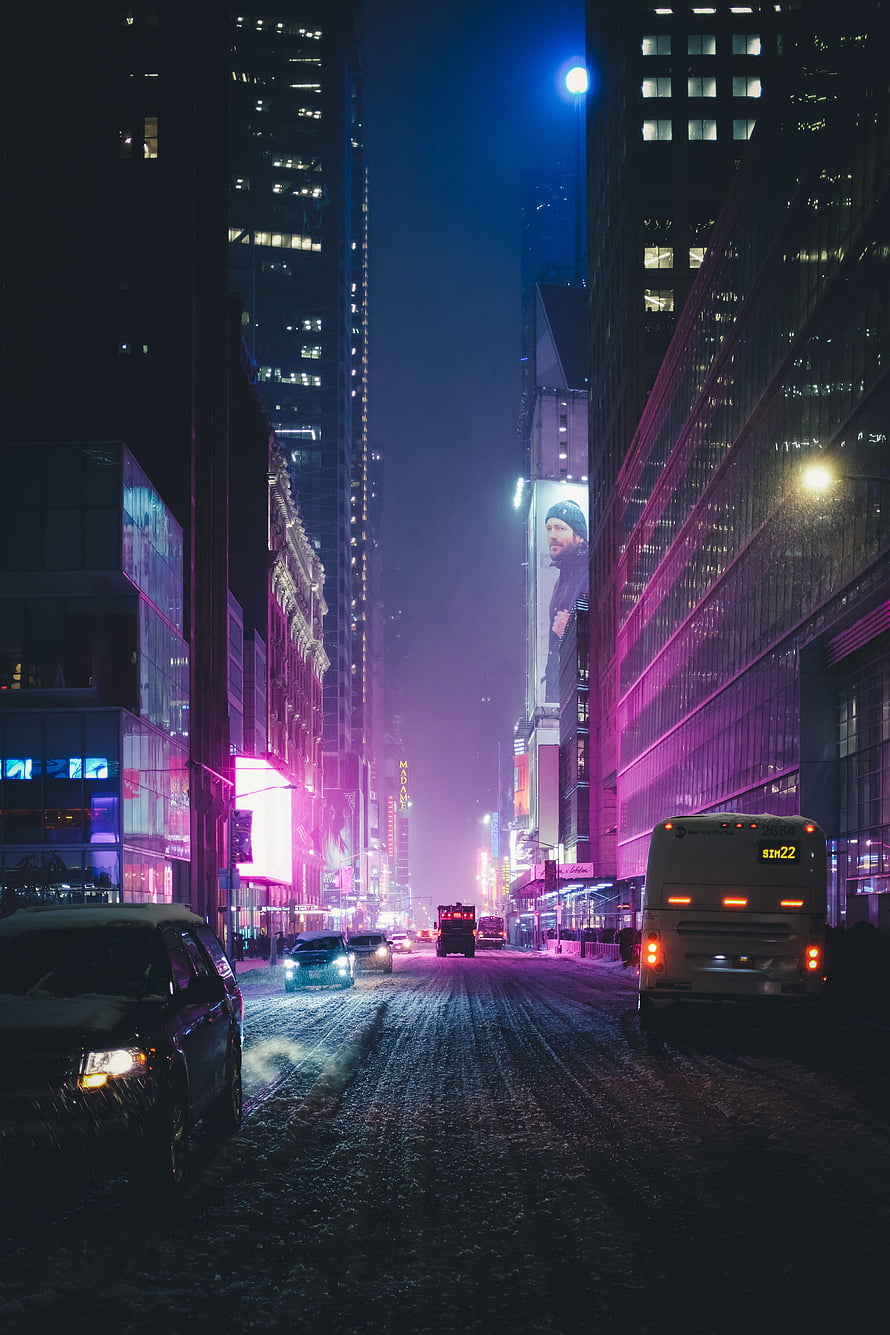 Snowy New York City Street at Night with Neon Lights and Skyscrapers HD phone wallpaper