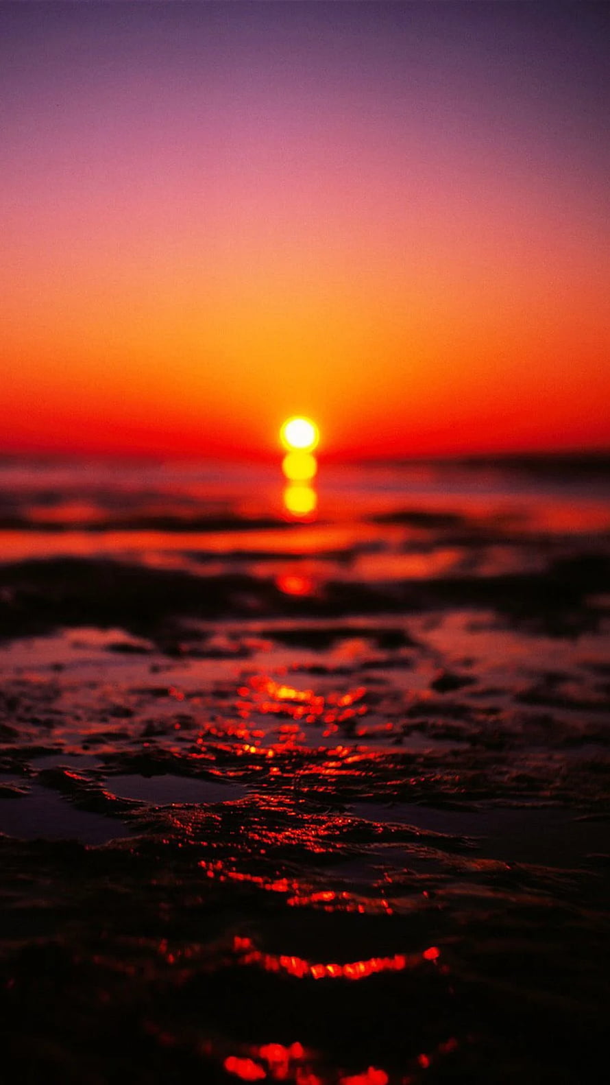 Vibrant Ocean Sunset with Glowing Horizon and Reflective Water Surface HD phone wallpaper