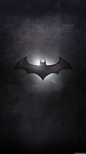 Gotham City Bat Signal Projected on Dark Concrete Wall with Dramatic Light Rays HD phone wallpaper